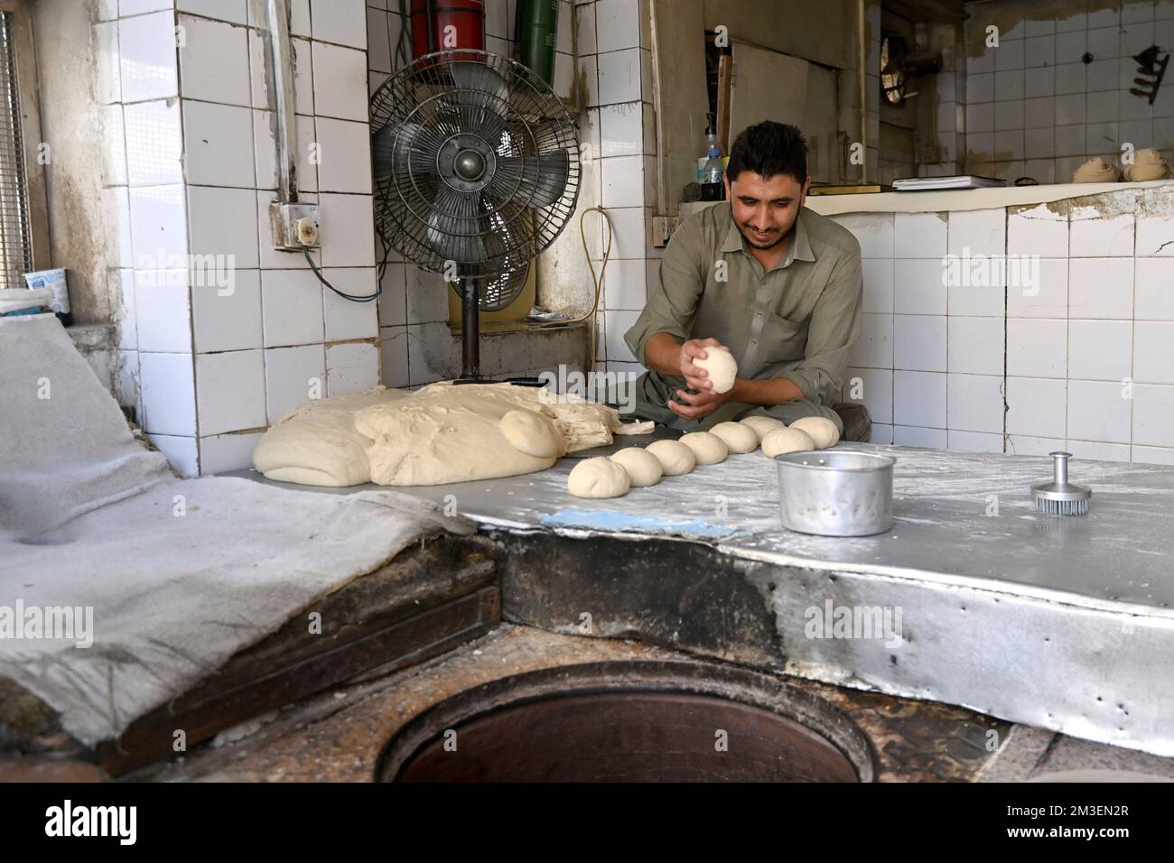 Doha, Katar. 12th Dec, 2022. A look into a tiny, small bakery. Baker