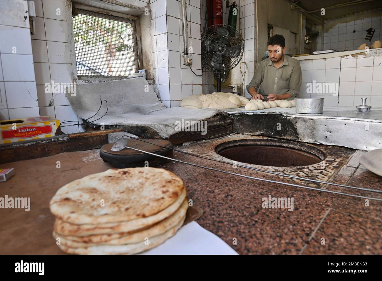 Doha, Katar. 12th Dec, 2022. A look into a tiny, small bakery. Baker