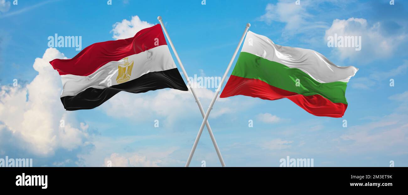 two crossed flags Bulgaria and Egypt waving in wind at cloudy sky ...