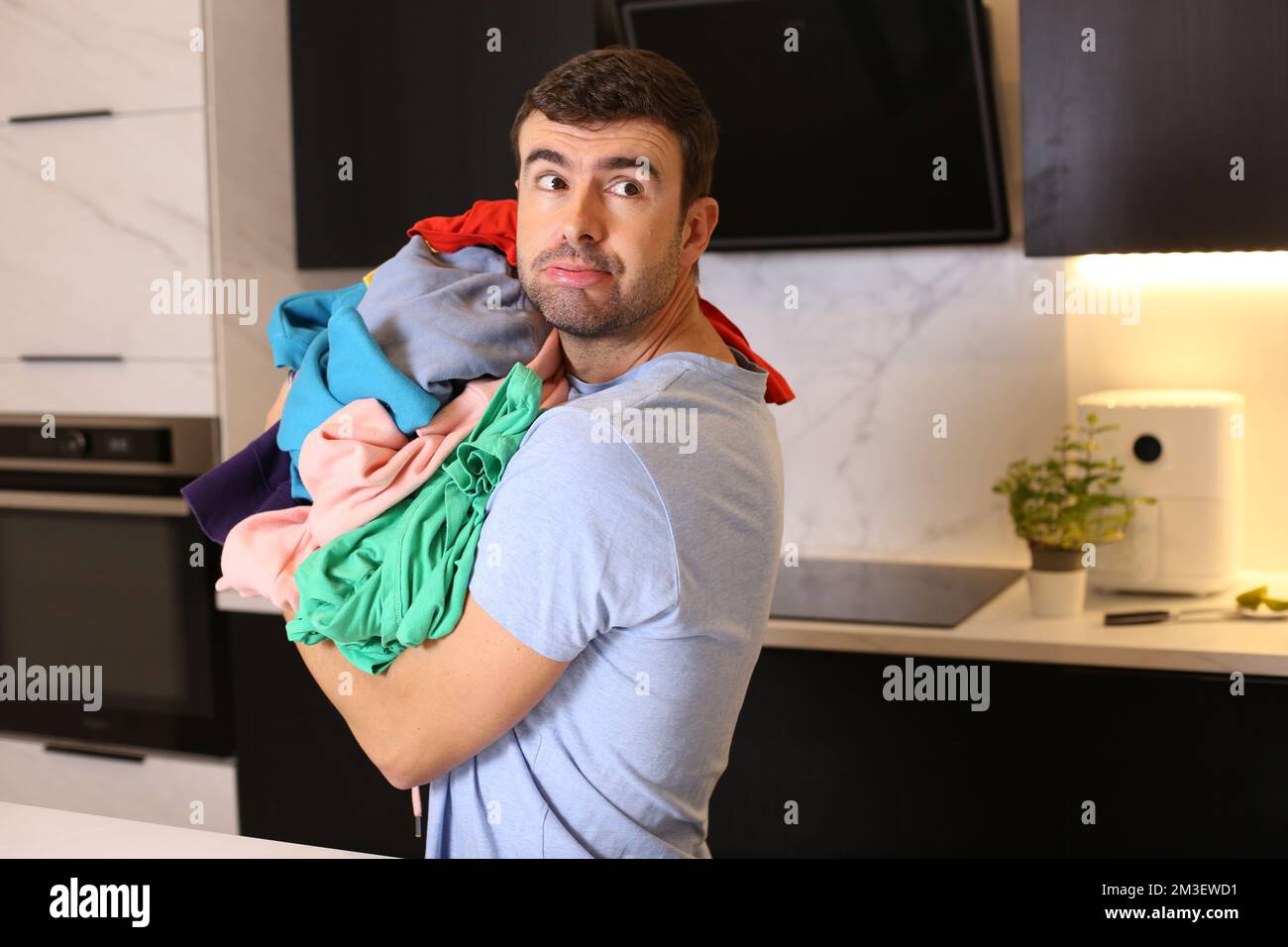 Cute man doing the laundry Stock Photo