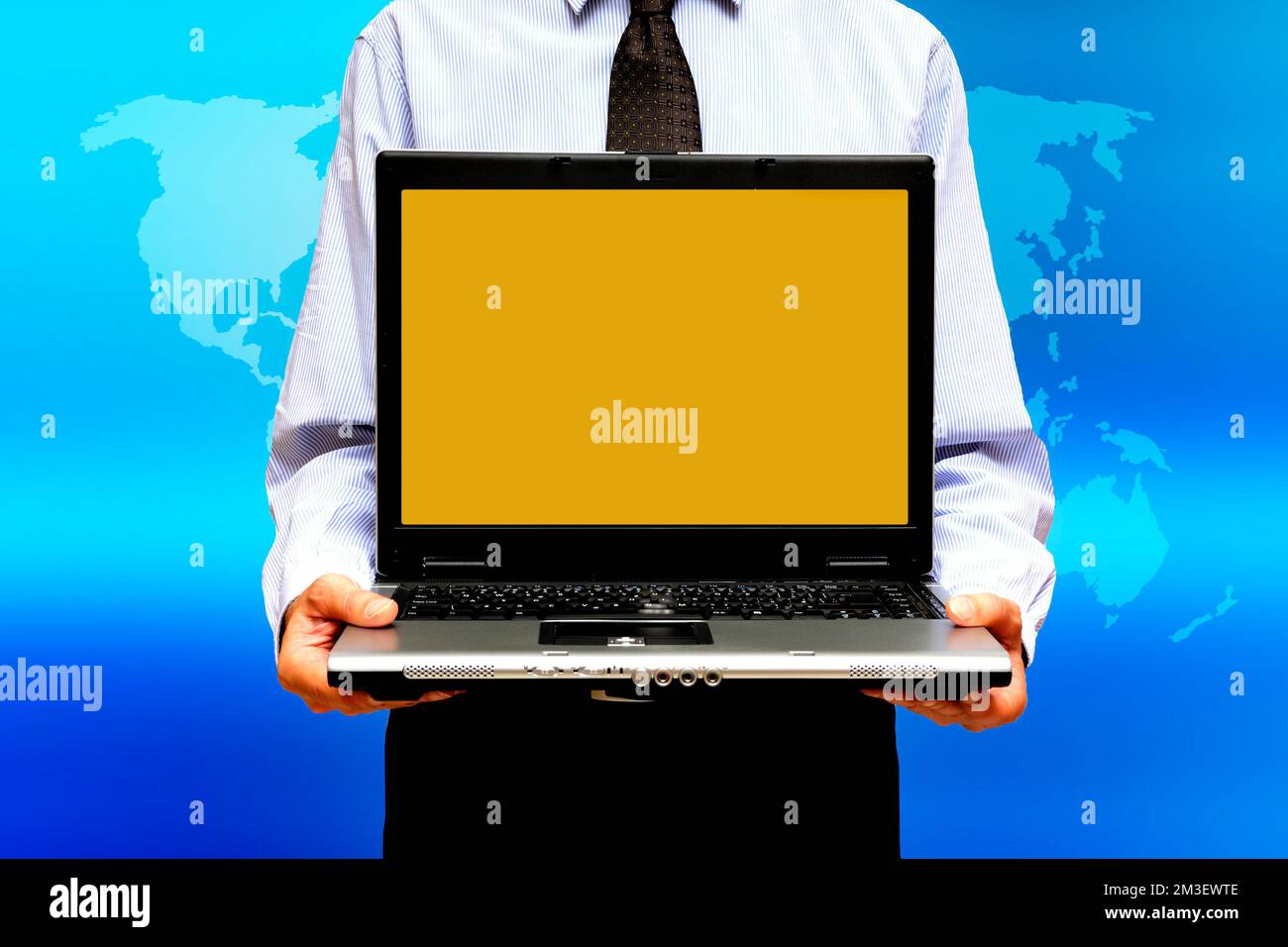 businessman holding a laptop with a blank screen over a world map, global business concept Stock Photo