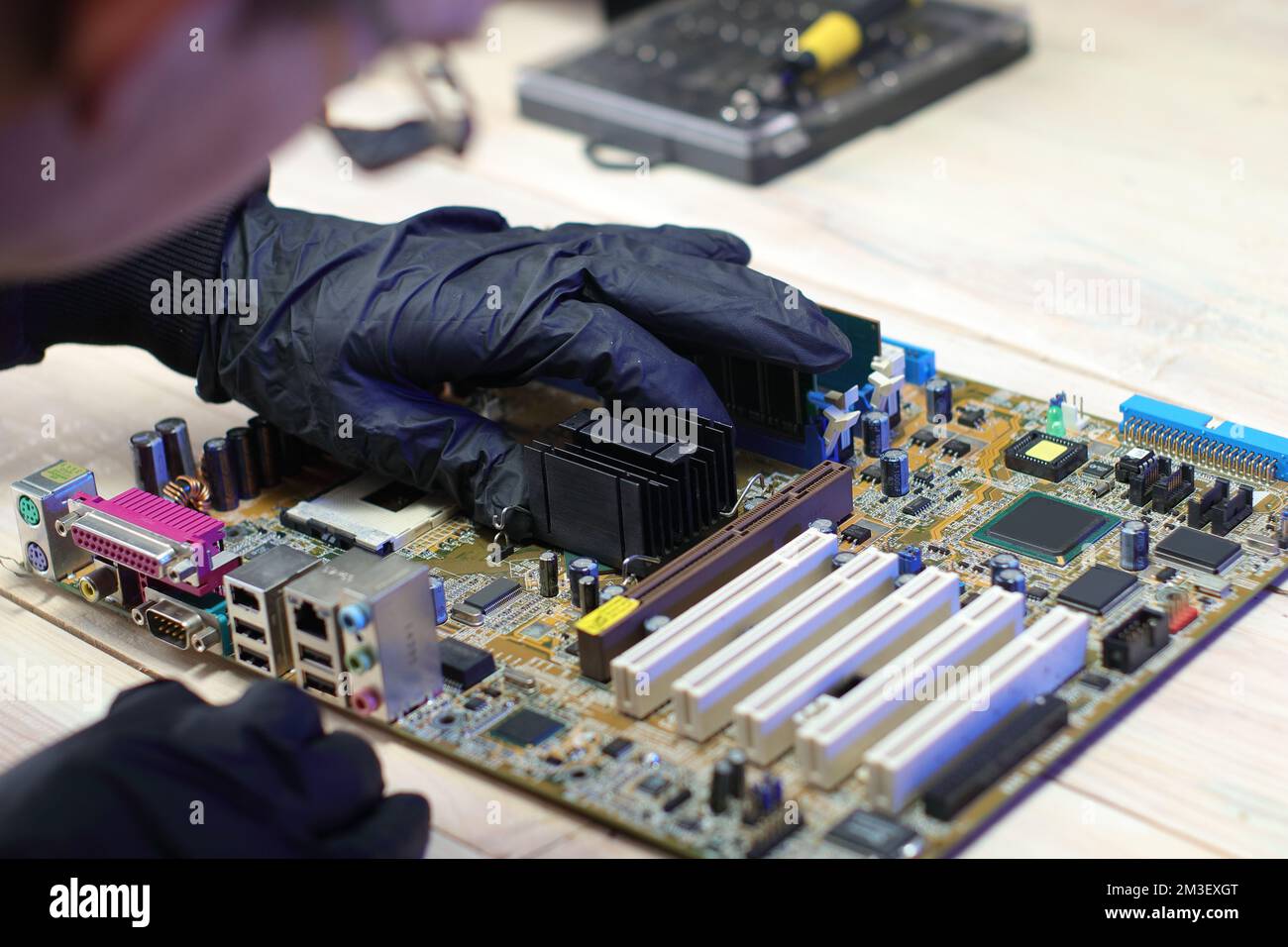 replacement of the chipset cooling system from the computer motherboard on the table Stock Photo