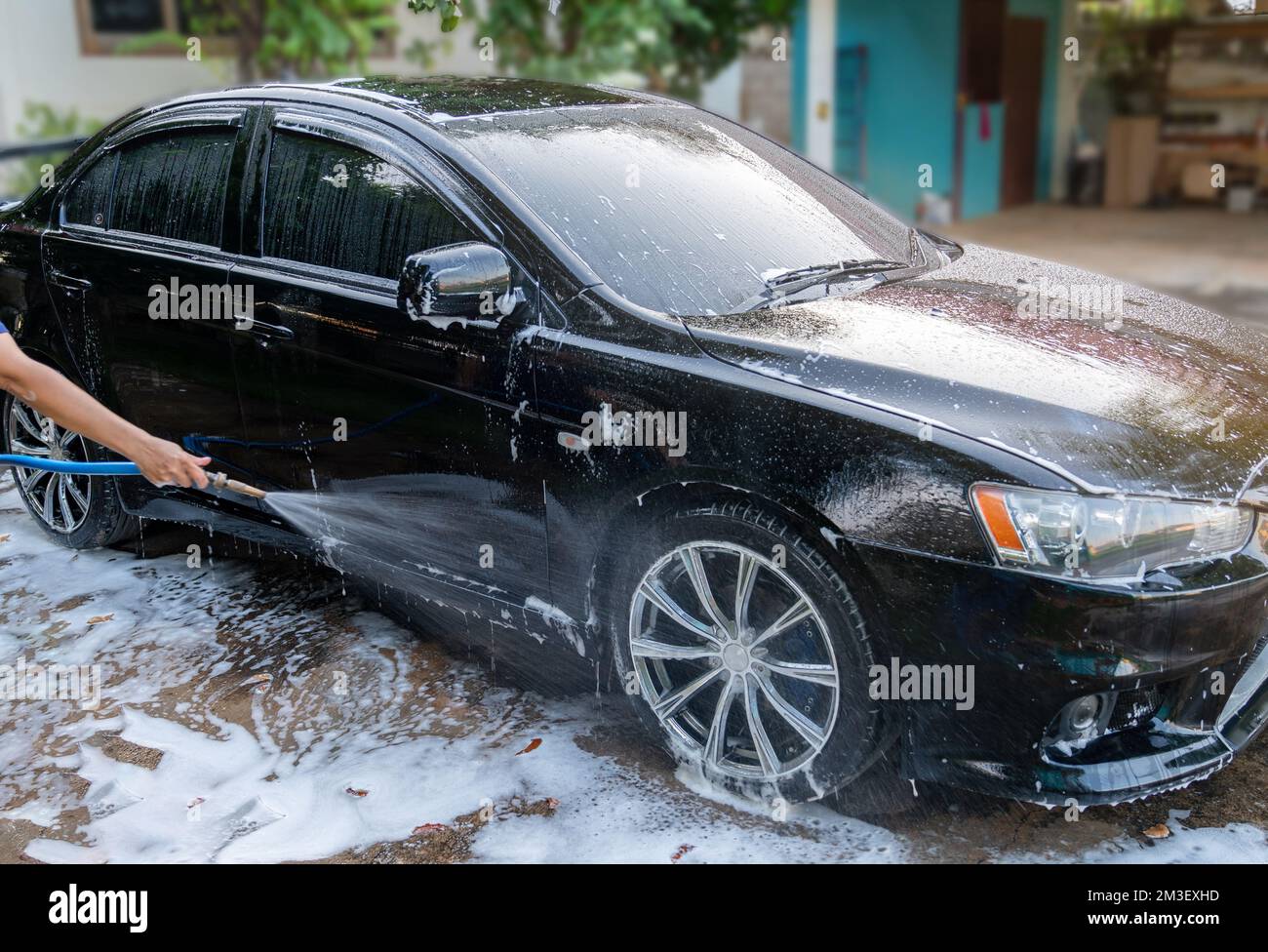 Car Wash with high pressure cleaner at home. Car detailing Stock Photo