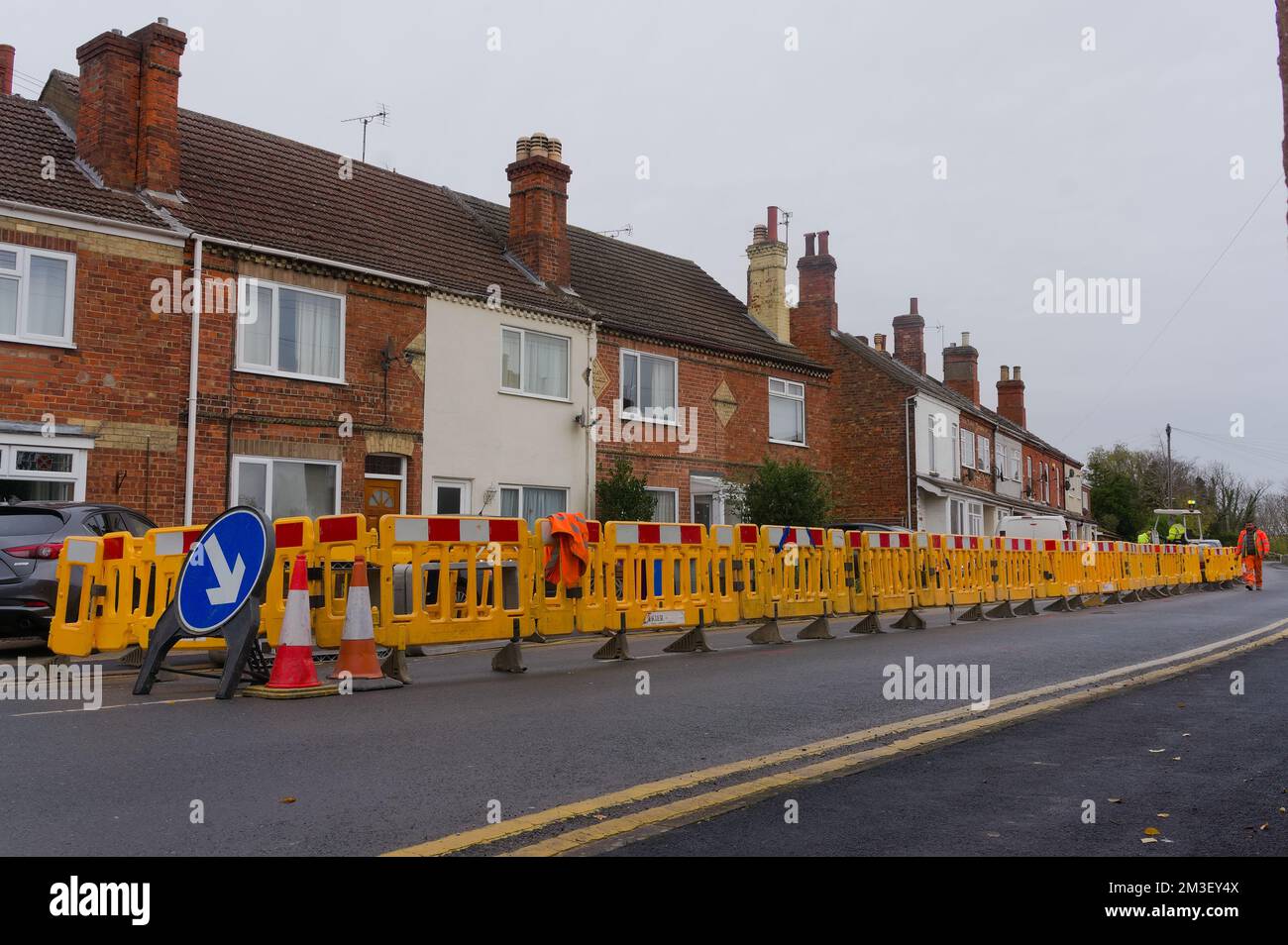 yellow barriers enclosing roadworks along wyberton west road Stock Photo