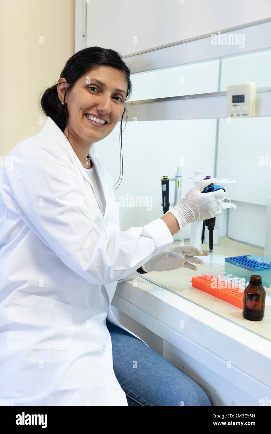 Scientist working in a fume cupboard in laboratory research Stock Photo