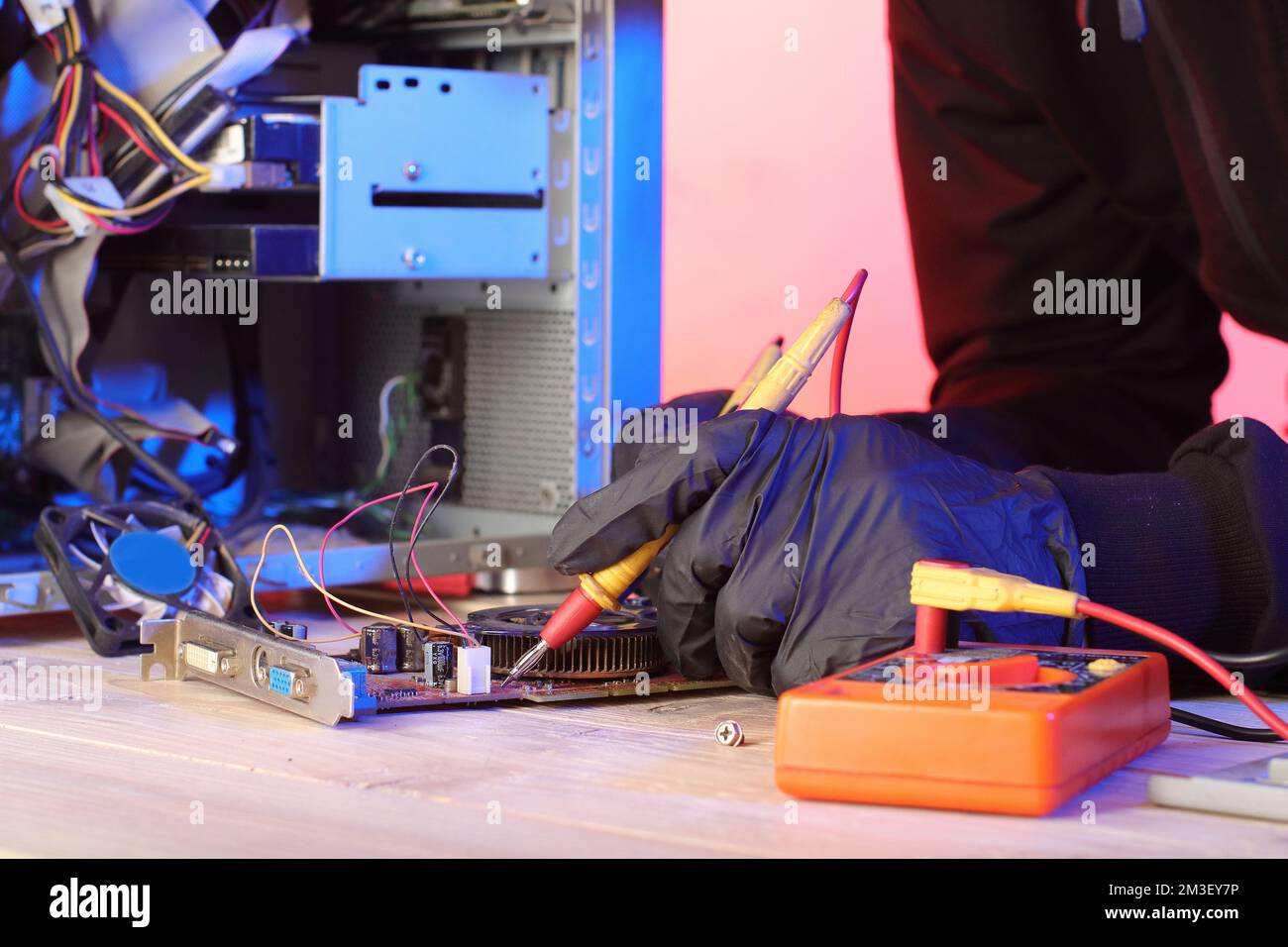 checking video card from desktop computer with ammeter on table Stock Photo