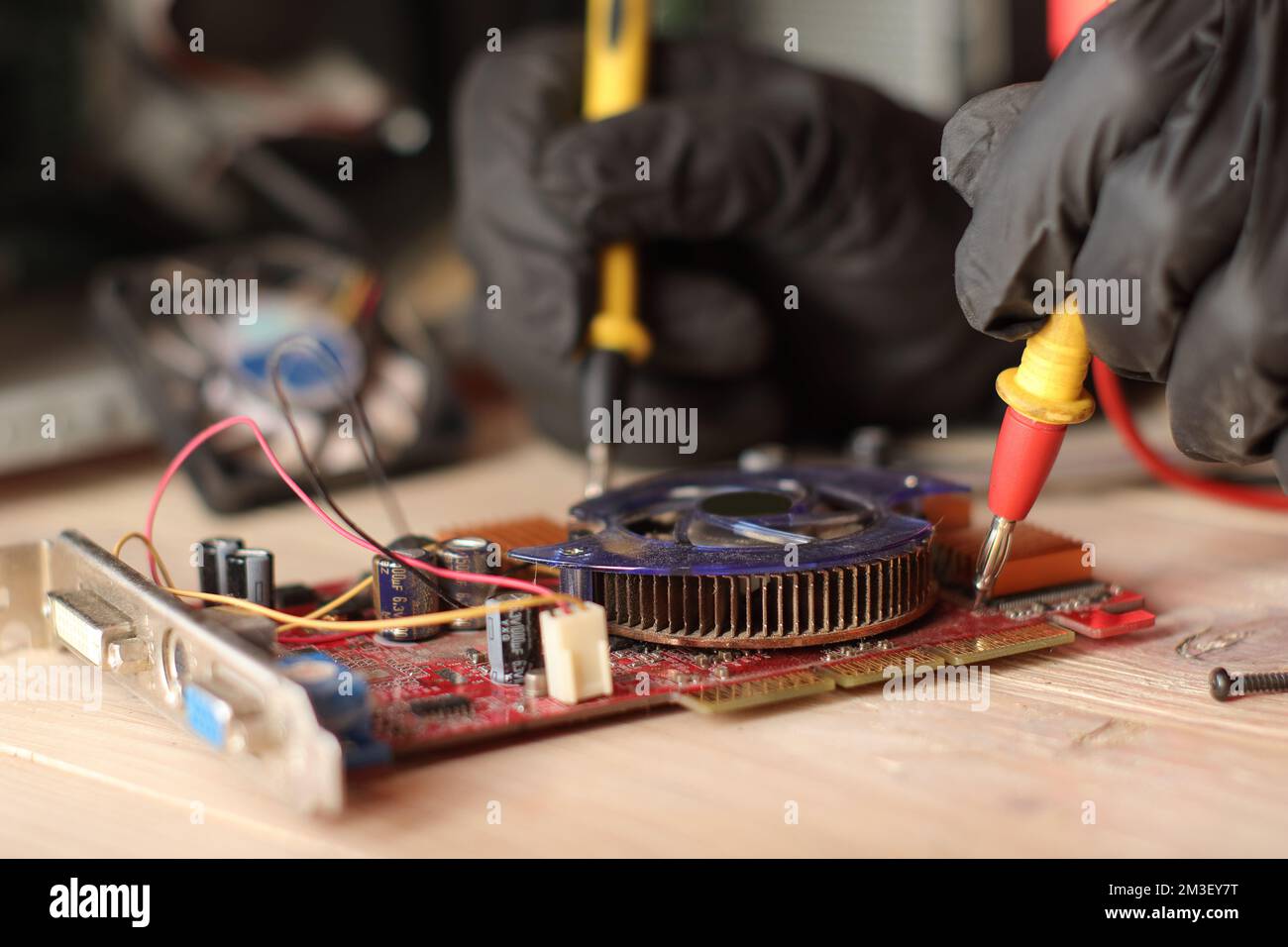 checking video card from desktop computer with ammeter on table Stock Photo