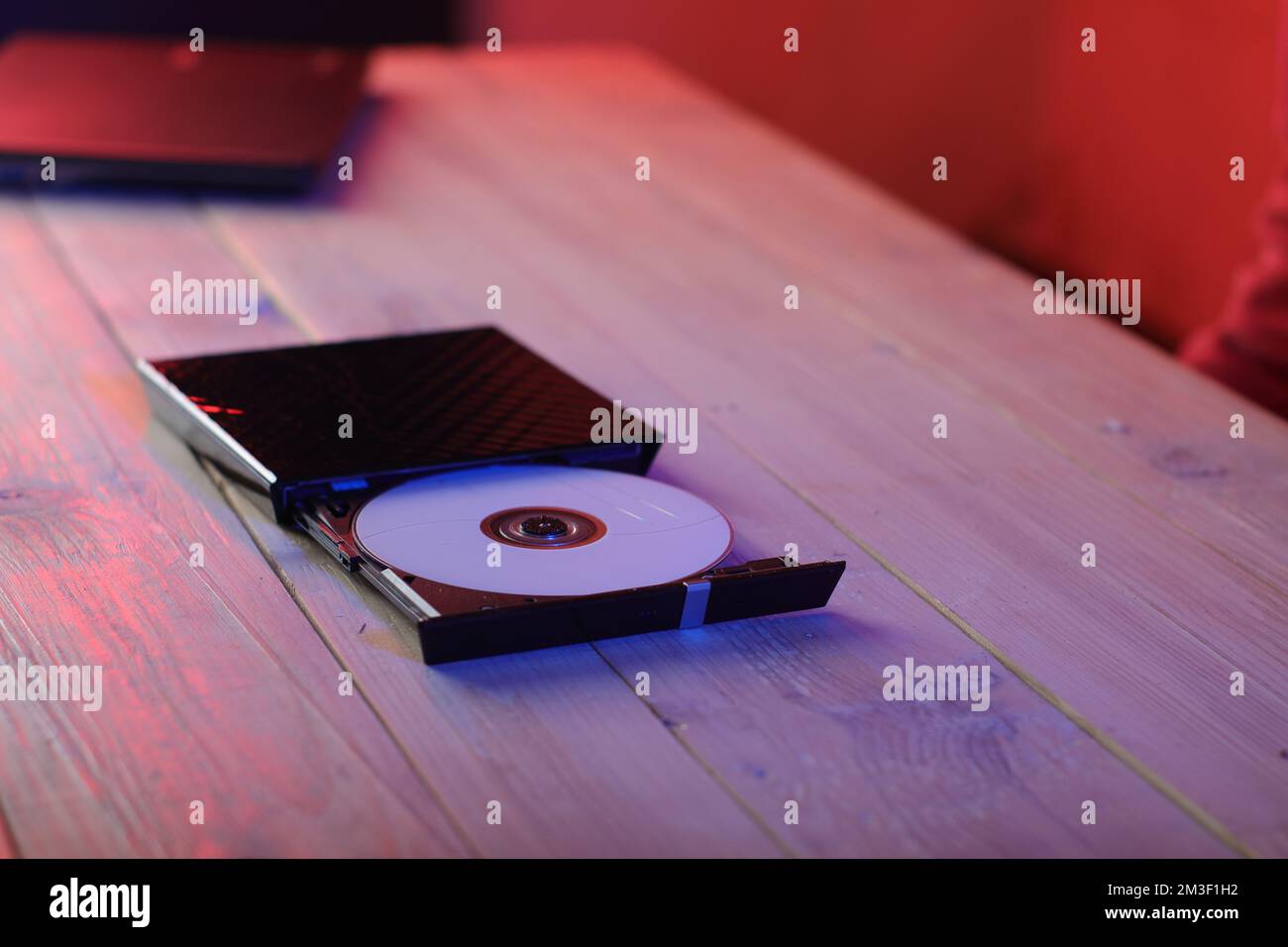 optical drive to from laptop with compact disc on table and colored