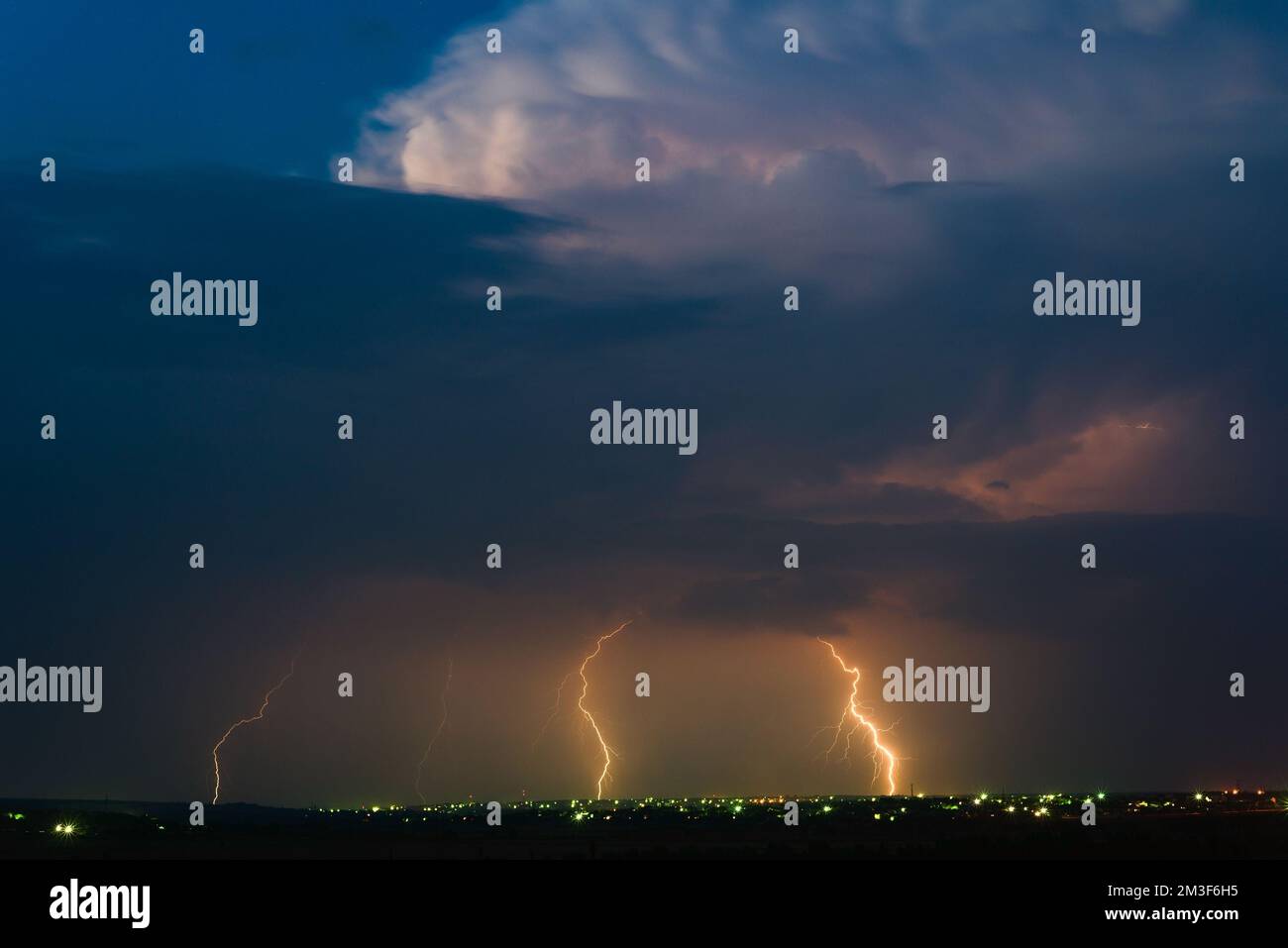 Panoramic view of a storm cloud illuminated by lightning flashes Stock