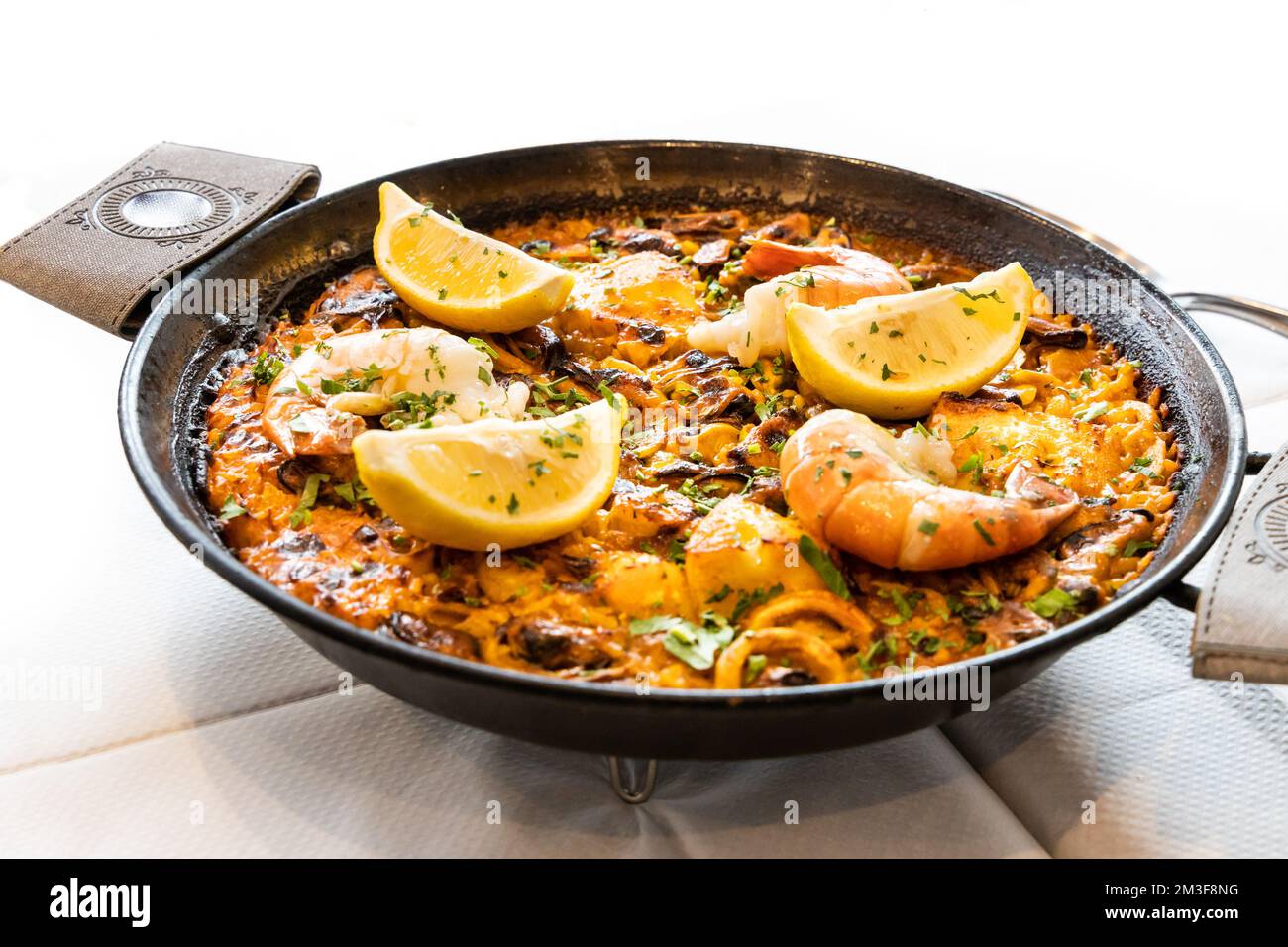 Close-up of typical delicious spanish paella with seafood in serving size Stock Photo