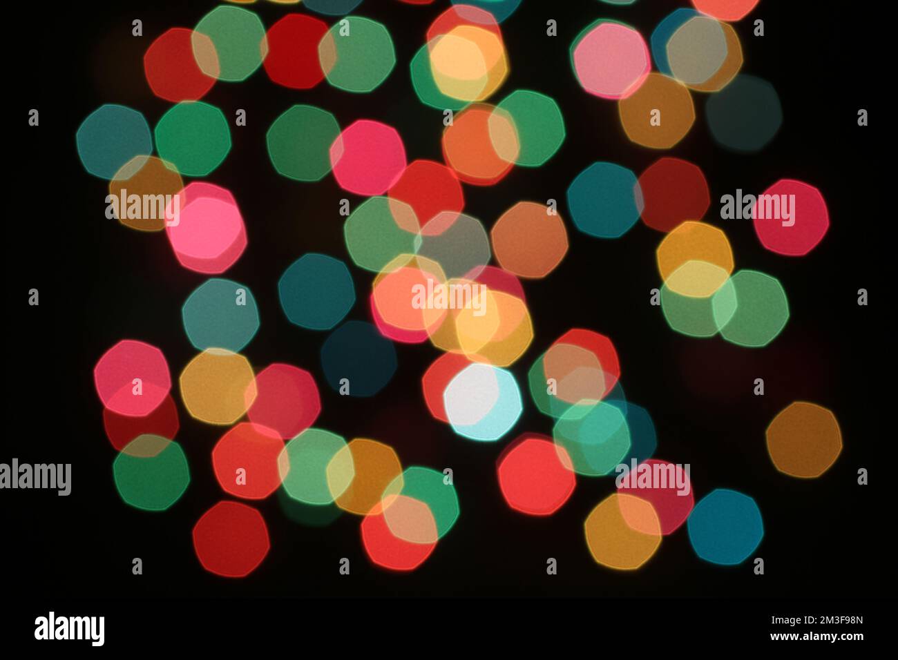 Defocused colorful lights on black background Stock Photo