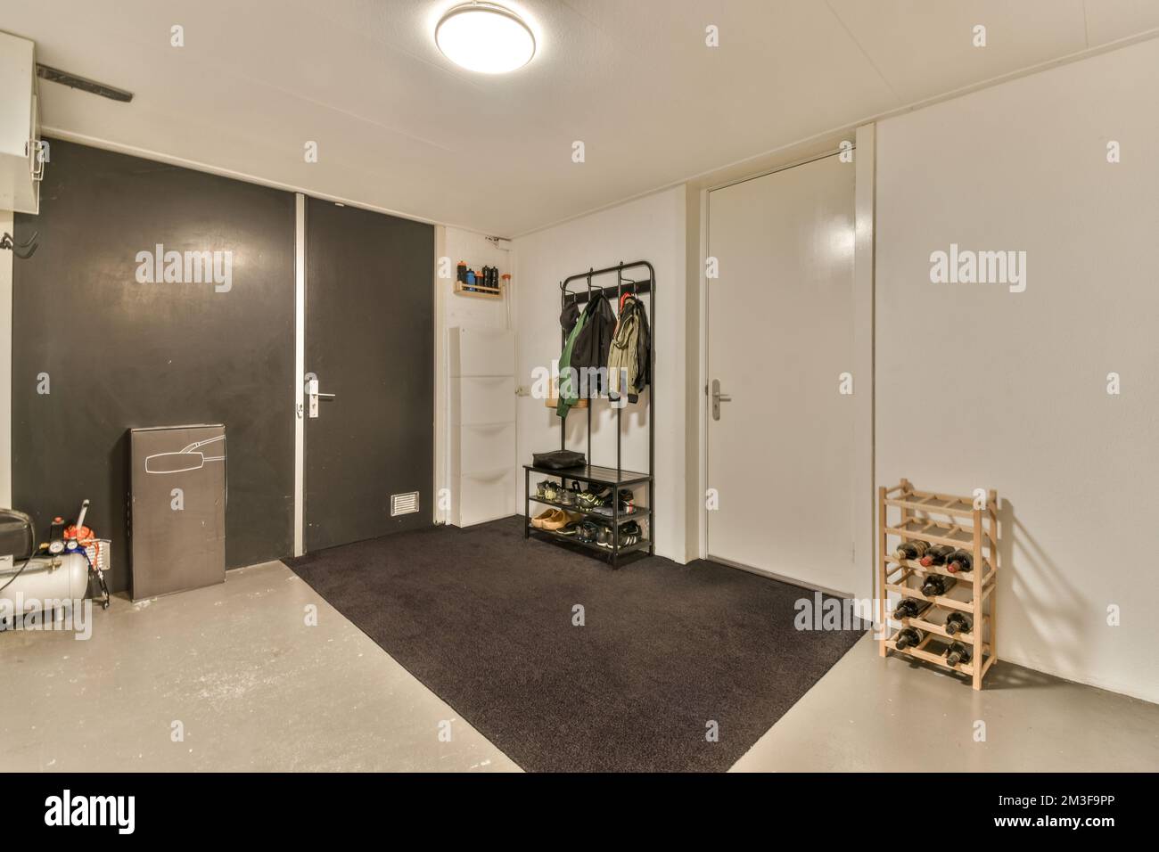 Hallway with many doors and engineering communications in spacious room