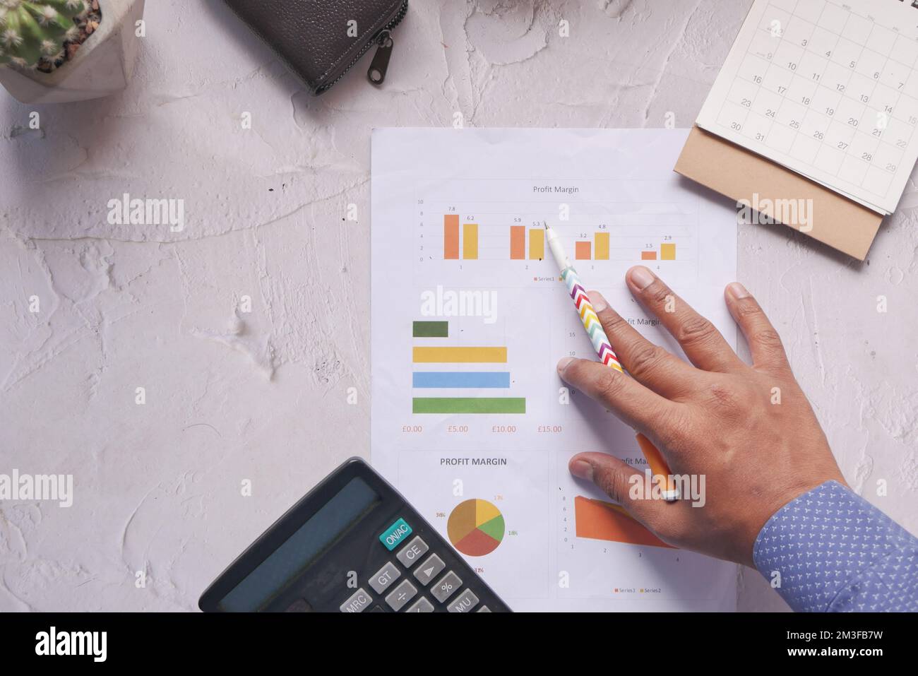 man hand with pen analyzing bar chart on paper  Stock Photo