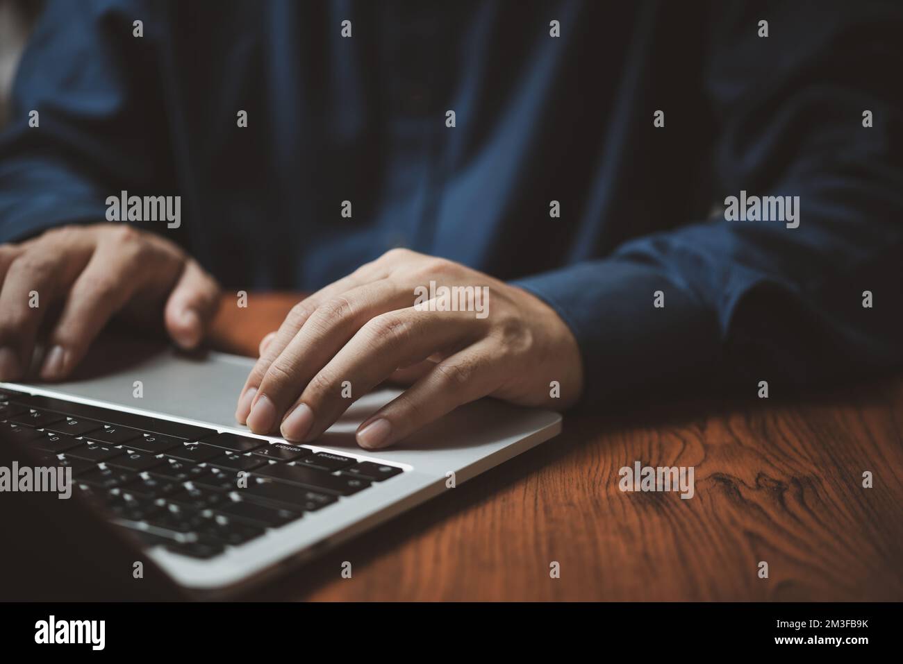 Man hands typing on laptop keyboard at the office. Stock Photo