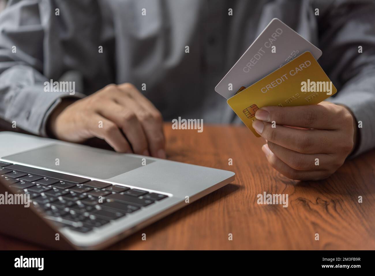 Man holding credit card on hand with laptop computer.Business financial internet banking online digital technology payment e commerce concept. Stock Photo