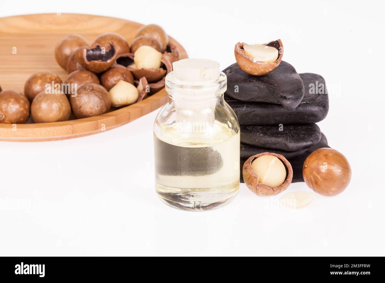 Macadamia nuts oil or Australian walnuts on white background Stock