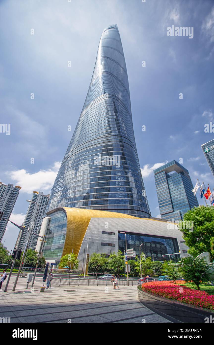 Shanghai Tower, Shanghai, China photographed from below with a wide lens in summer against a blue sky and clouds Stock Photo