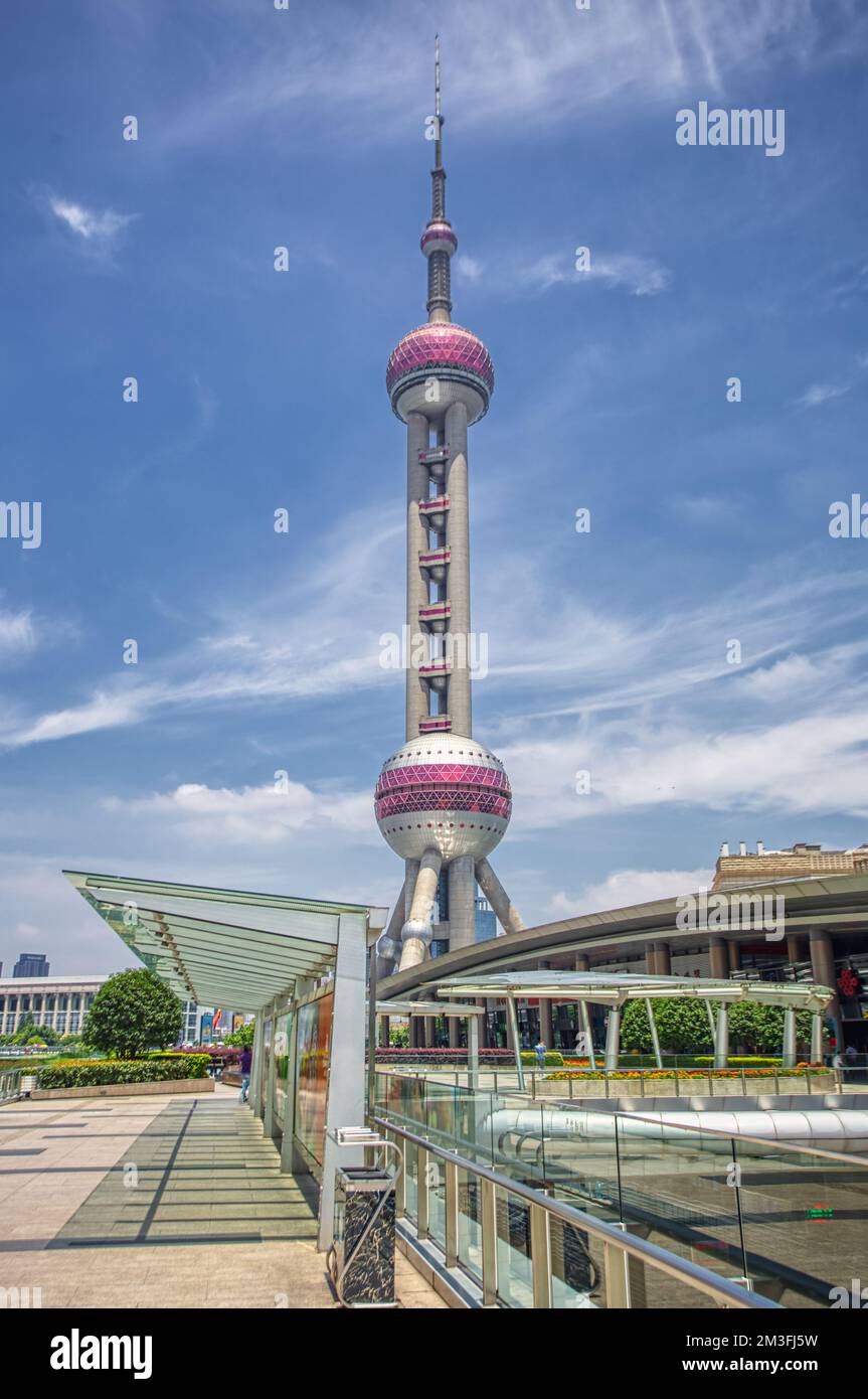 Oriental Pearl Tower, Shanghai, China shot with a wide lens in summer against blue sky and clouds Stock Photo