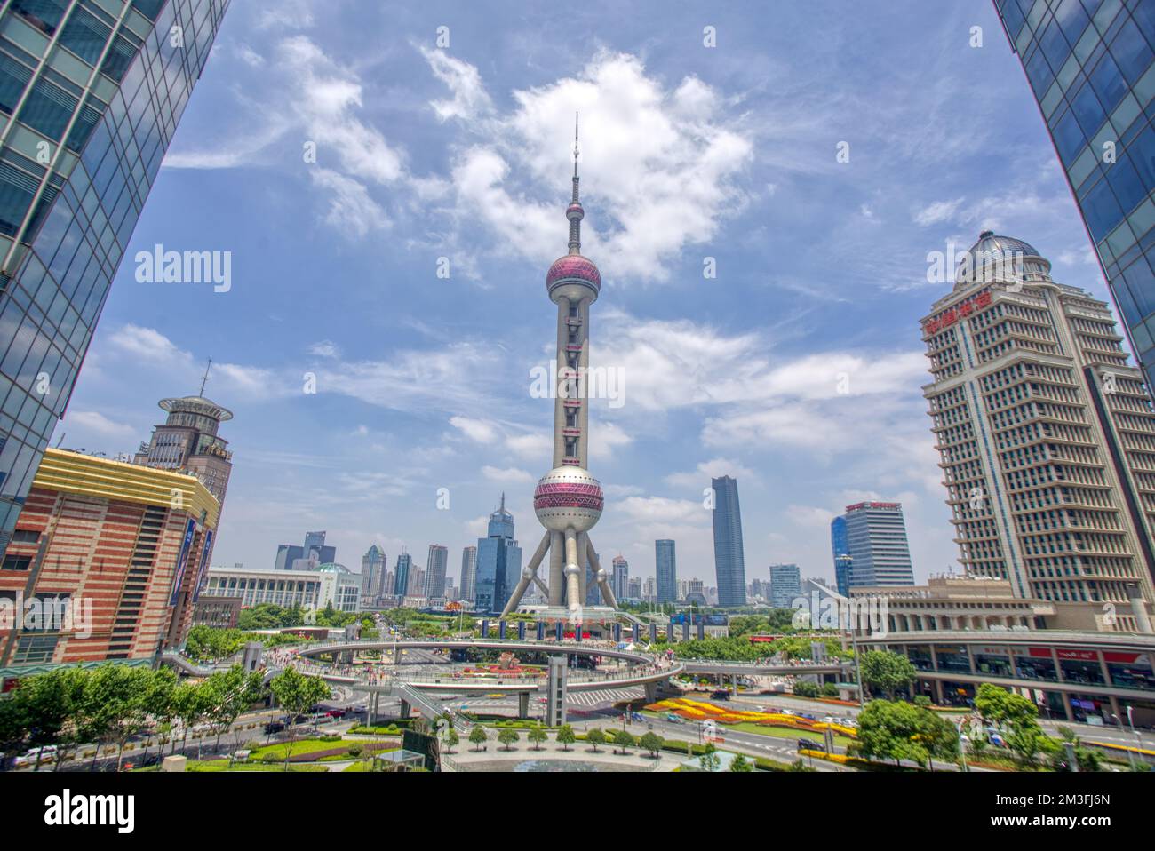 Oriental Pearl Tower, Shanghai, China shot with a wide lens in summer against blue sky and clouds Stock Photo