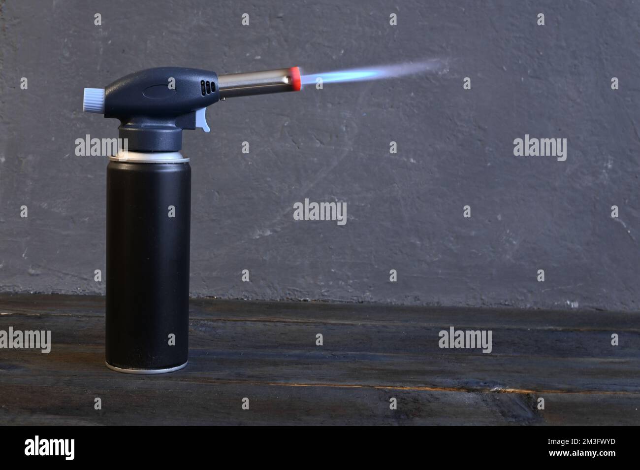 the gas soldering iron on the cylinder is on fire. High quality photo Stock Photo