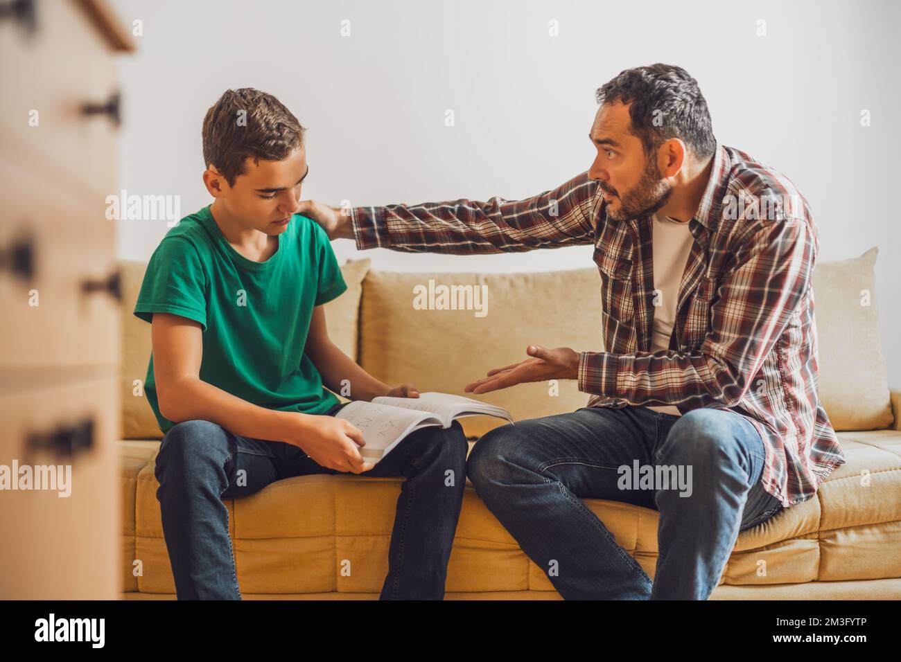 Father is helping his son with learning. Boy is having problem with homework. Stock Photo