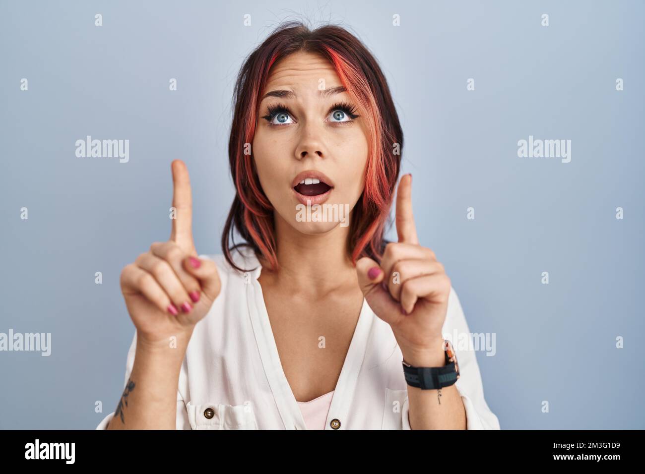 Young caucasian woman wearing casual white shirt over isolated ...