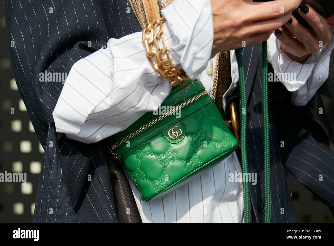 MILAN - SEPTEMBER 23: Woman with green Furla bag, orange and yellow jacket  and white wedge heel shoes before Antonio Marras fashion show, Milan Fashio  Stock Photo - Alamy