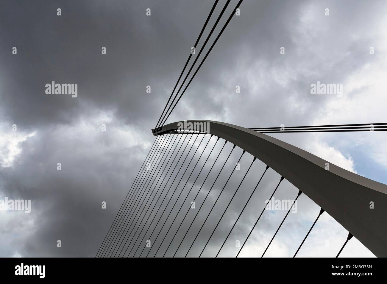 Samuel Beckett Bridge, detail of the cable-stayed bridge against a dramatic cloudy sky, modern architecture, architect Santiago Calatrava, Dublin Stock Photo