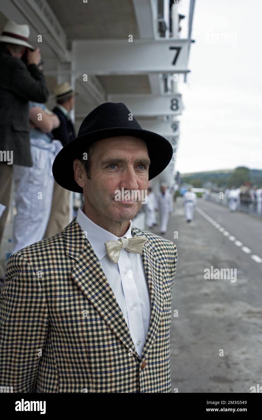 Enthusiast s enjoy dressing in period clothes to take part in and to enjoy the atmosphere of the Goodwood Revival which is held in Sussex, England. Stock Photo