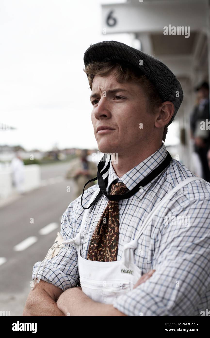 West Sussex, England Mechanic watching the race in the paddock at the