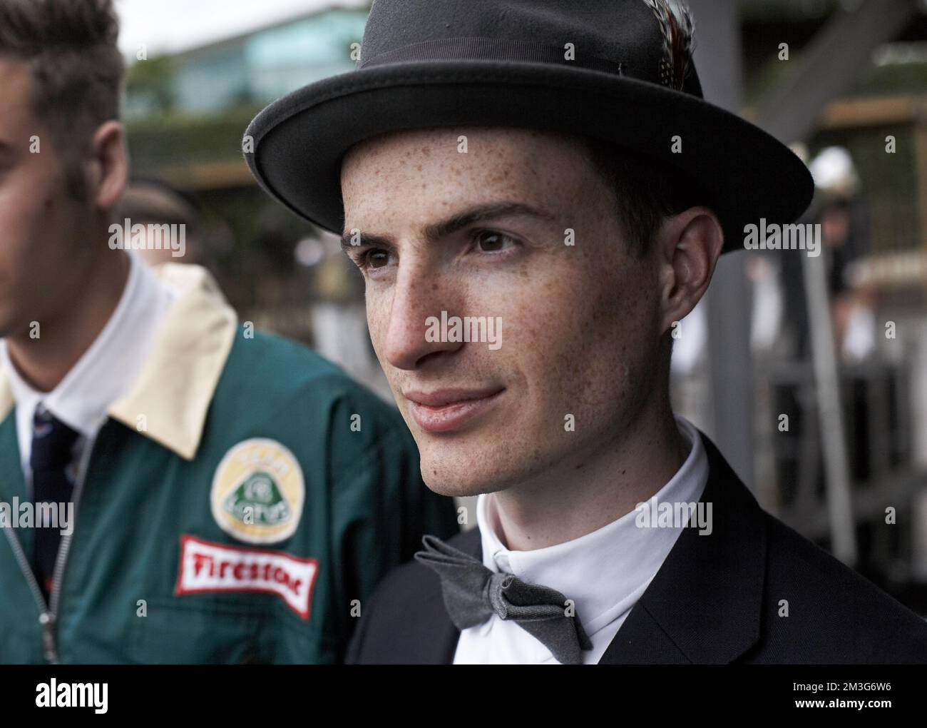 Enthusiasts enjoy dressing in period clothes to take part in and to enjoy the atmosphere of the Goodwood Revival which is held in Sussex, England. Stock Photo