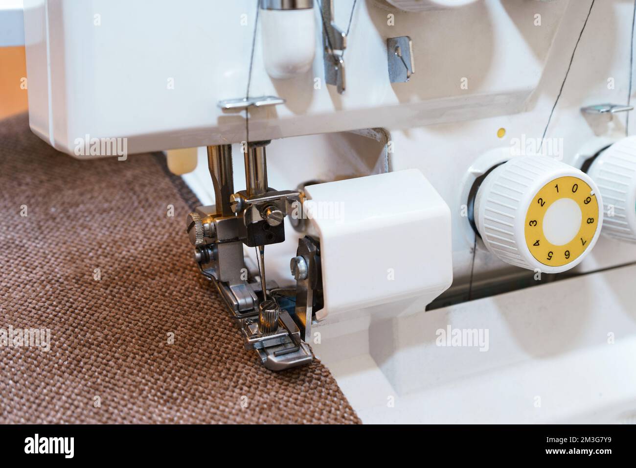 Professional equipment. Modern overlock sewing machine pressure foot in