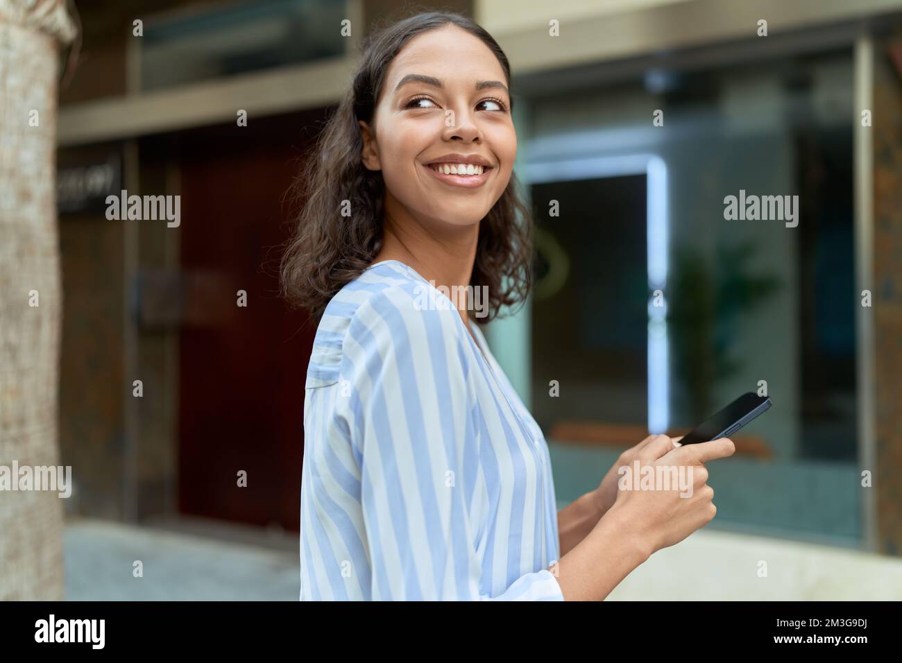 Young african american woman smiling confident using smartphone at ...
