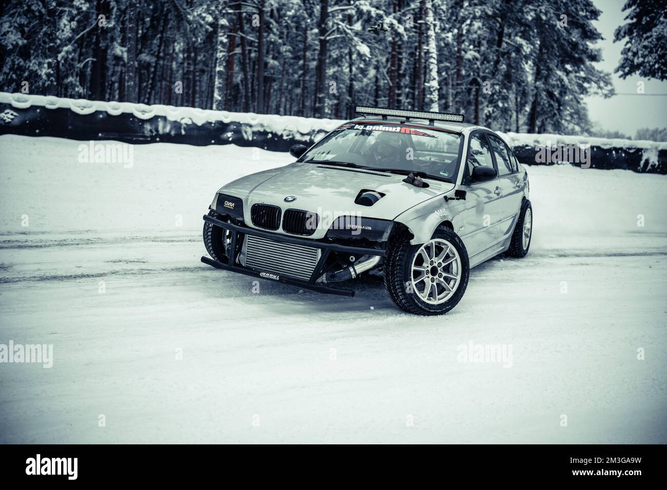 12-12-2022 Riga, Latvia  a car parked in the snow in front of some trees and snow covered ground with a few snow on the ground. . Stock Photo