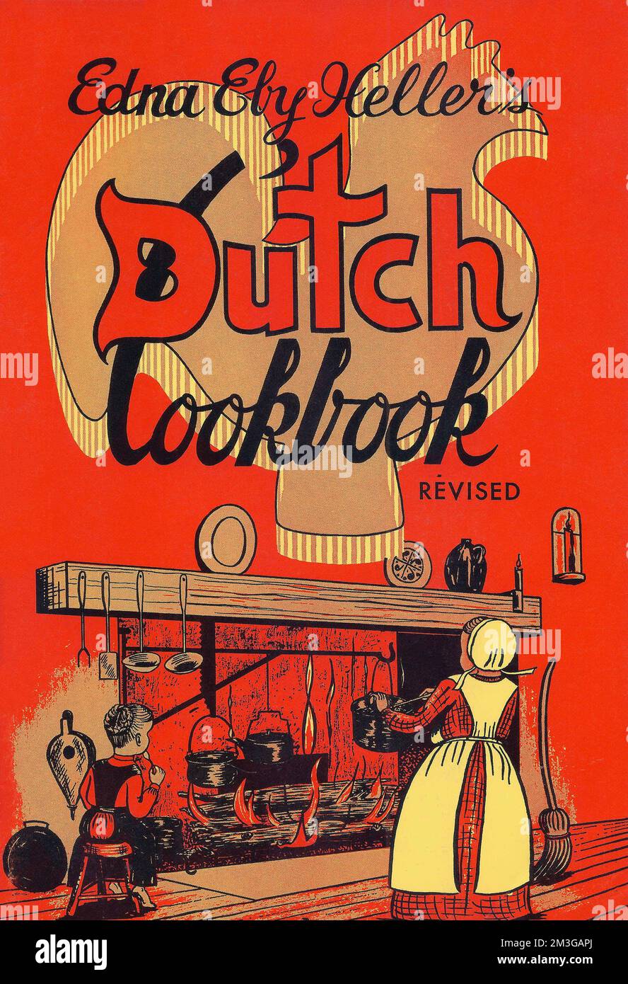 The cover of this 1974 cookbook features Amish girls cooking on an open hearth that is, in reality, a faux hearth in the museum of the Historical Society of Berks County, Pa. Stock Photo