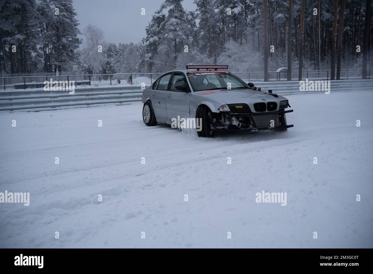 12-12-2022 Riga, Latvia  a car that is sitting in the snow with a ski rack on top of it's roof and a ski rack on the front of it. . Stock Photo