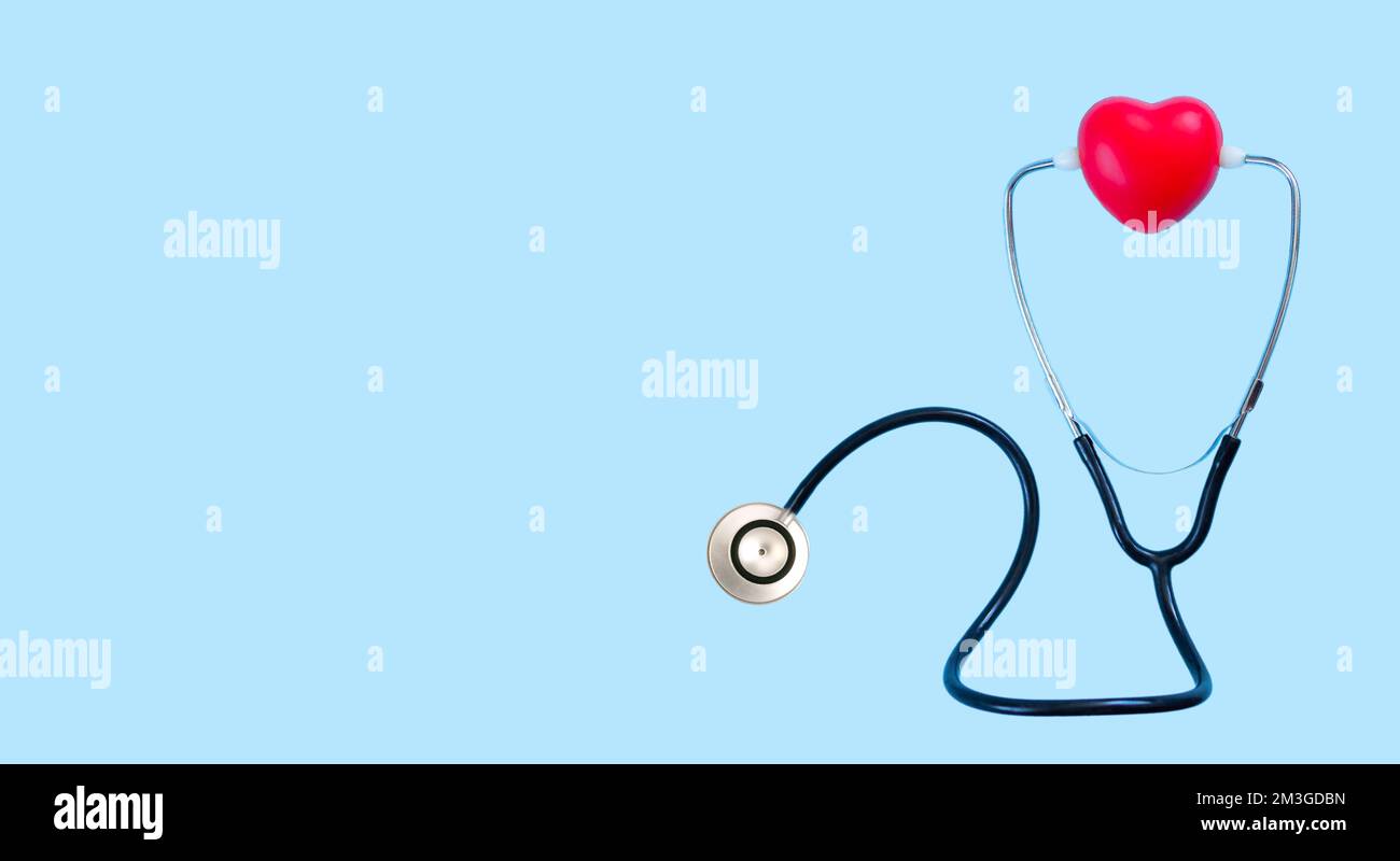 Red heart and stethoscope top view on blue background. Listening heartbeat concept Stock Photo