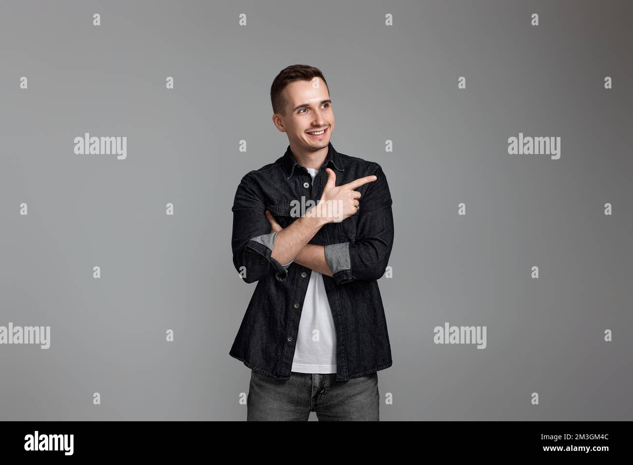 Young handsome man pointing to the side copy space Stock Photo