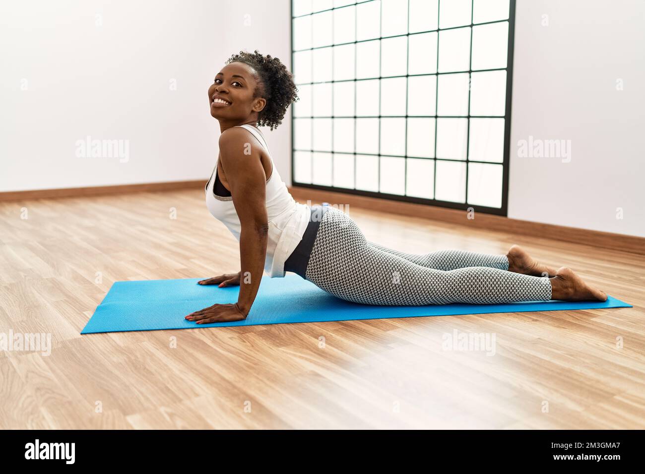 African american woman smiling confident stretching back at sport ...