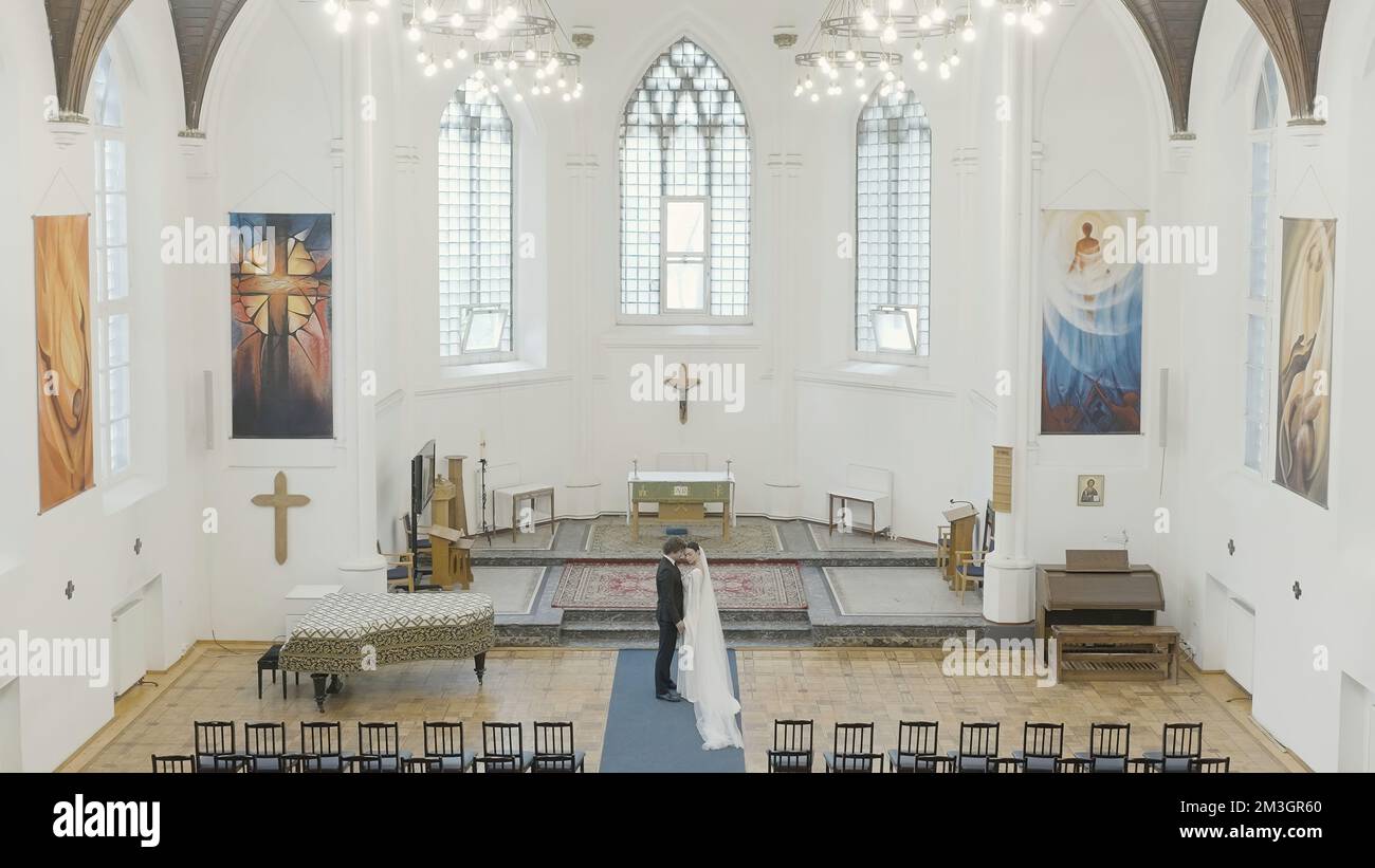Wedding photography in the temple. Action.A young couple with a ...