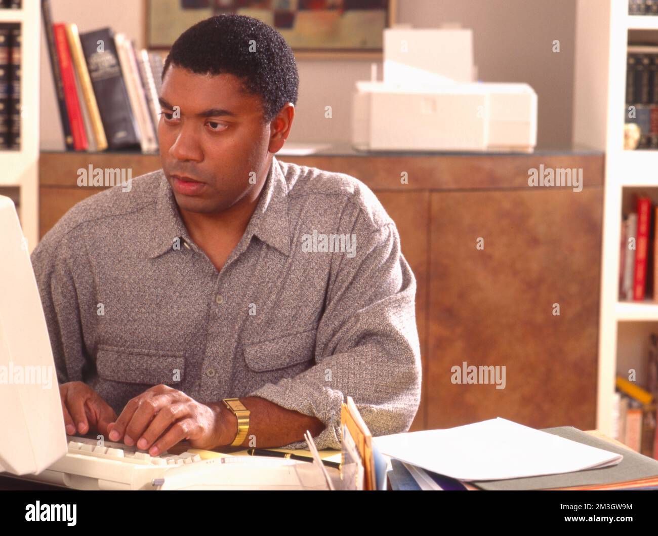 African-American man working on a computer Stock Photo
