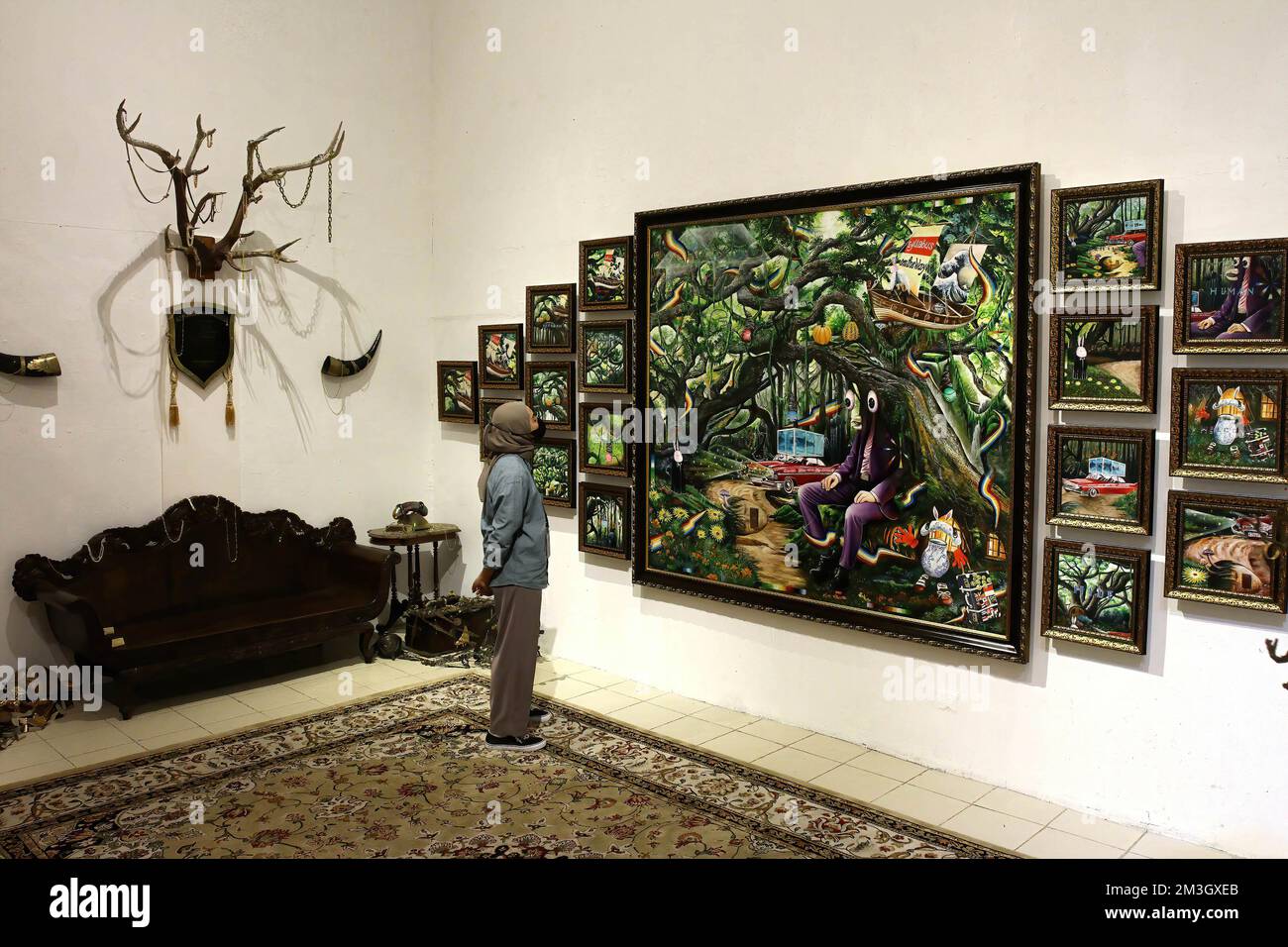 Yogyakarta, Indonesia. 15th Dec, 2022. A visitor observes the works on