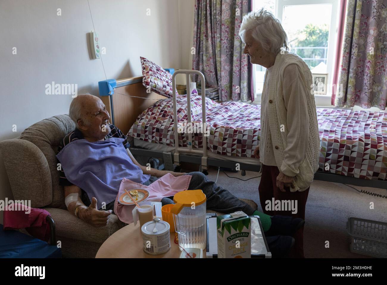 Elderly couple in their 80's together in their bedroom at a care home in Southwest England, UK Stock Photo