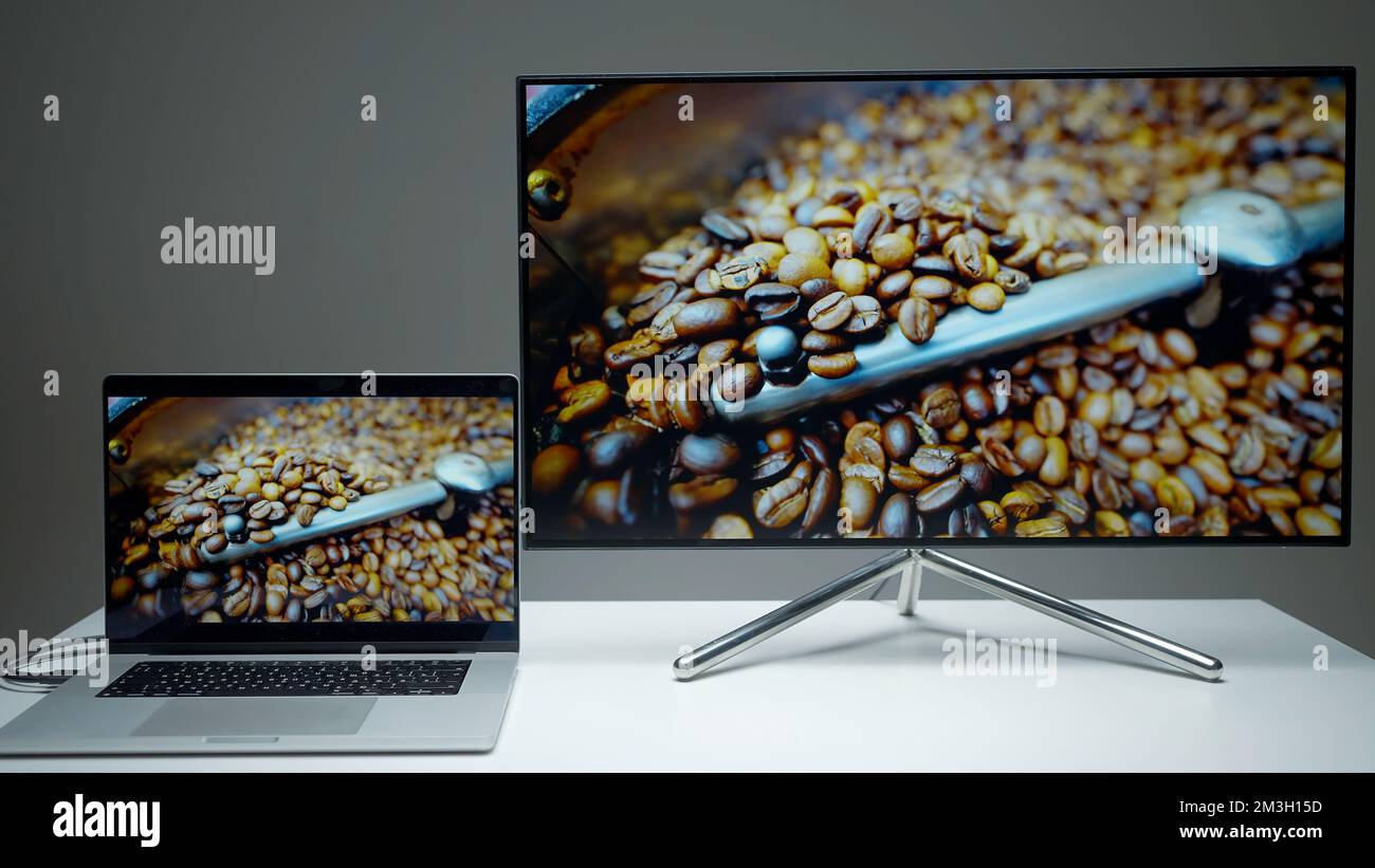 Laptop transmitting an image via hdmi on a TV screen. Action. Computer