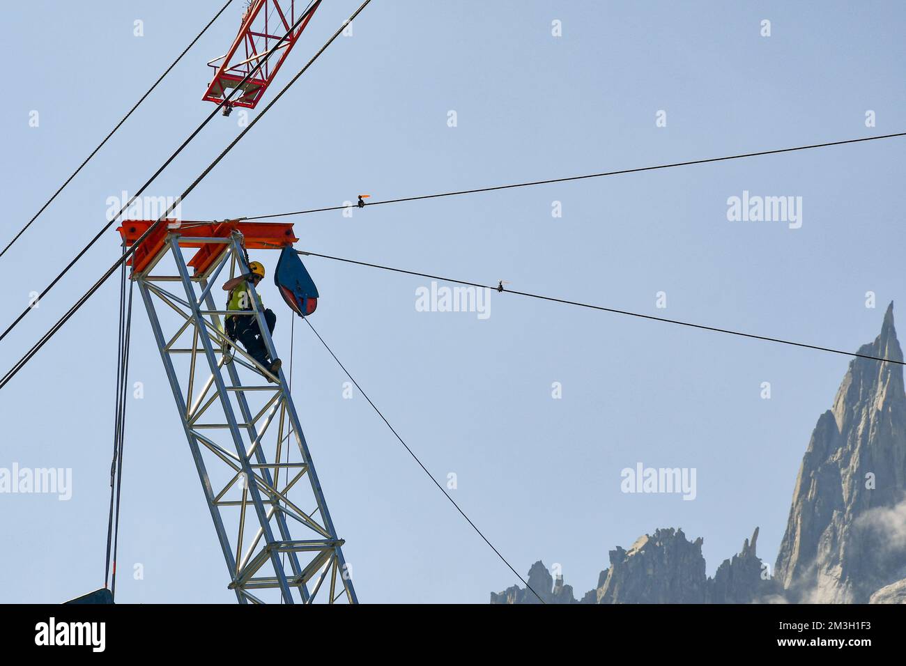 A worker on the top of a crane at the Montenvers station for the construction of the new Mer de Glace (Sea of Ice glacier) gondola lift, Chamonix Stock Photo