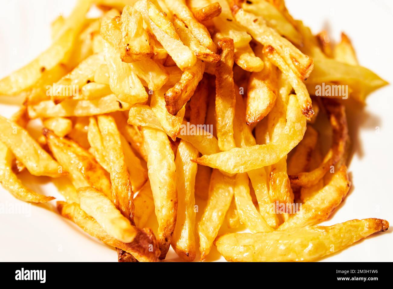 French fries on a white plate. Greasy and unhealthy food Stock Photo