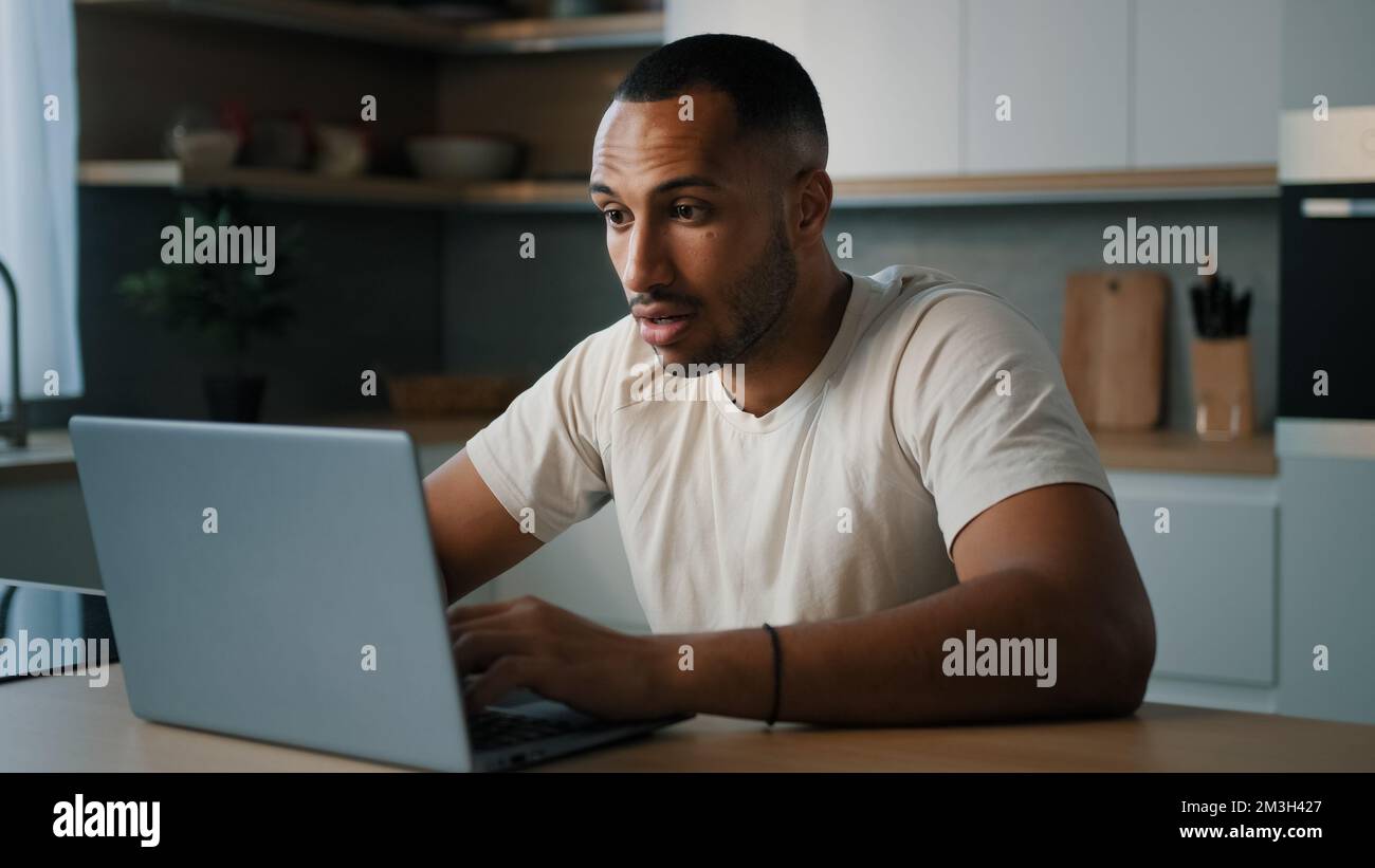 African sad upset worried man American dissatisfied guy male worry about online problem slow connection low computer battery failure lose with laptop Stock Photo