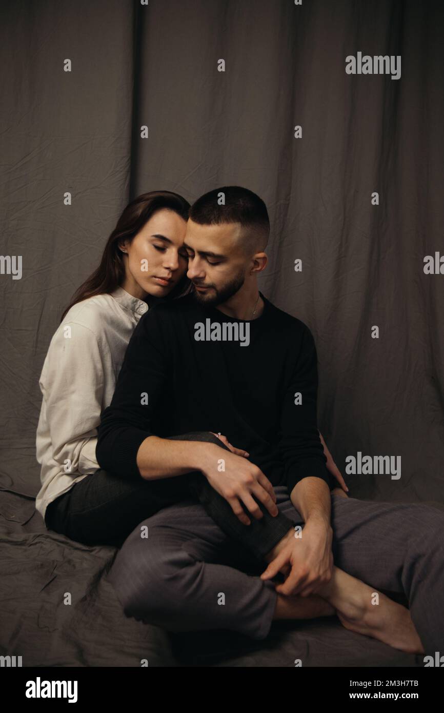 the girl hugs her boyfriend from behind Stock Photo - Alamy