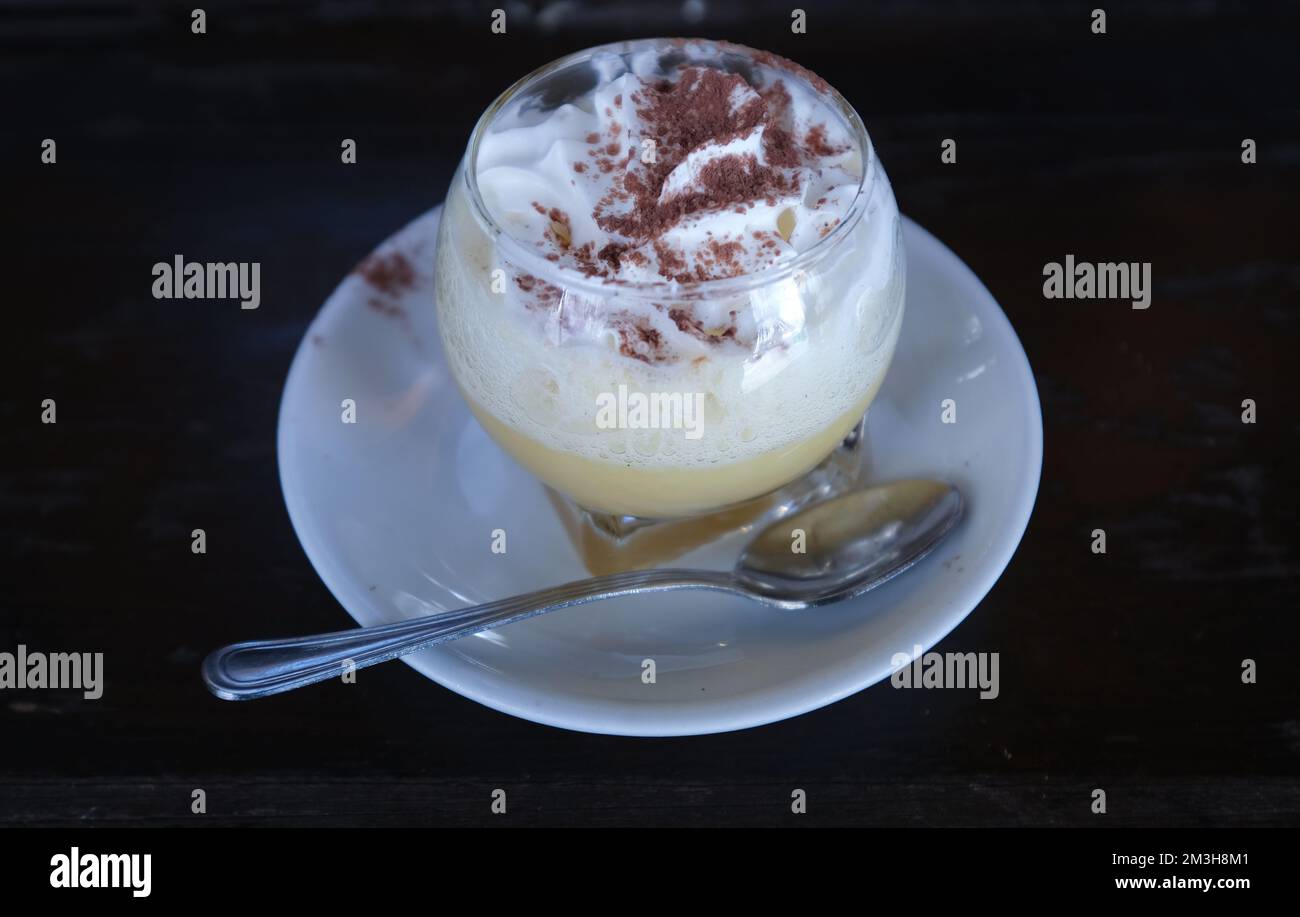 The Bombardino,Winter Cocktail drink made with cream, hot zabaione, brandy and coffee. Stock Photo