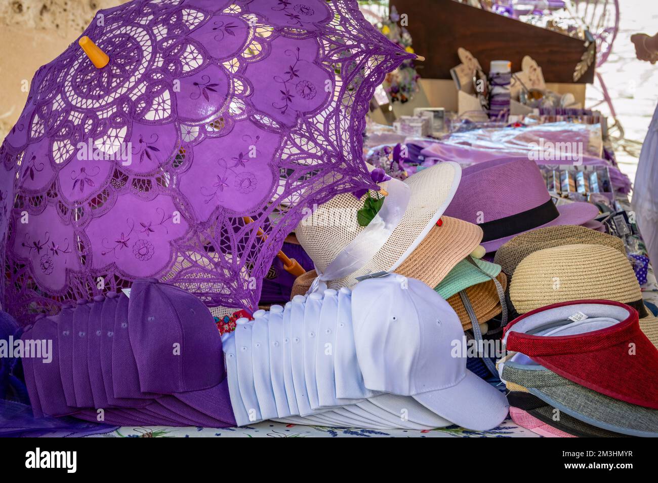 Embroidered violet umbrella and hats on Brhuega's street market. Lavender festival, Spain Stock Photo